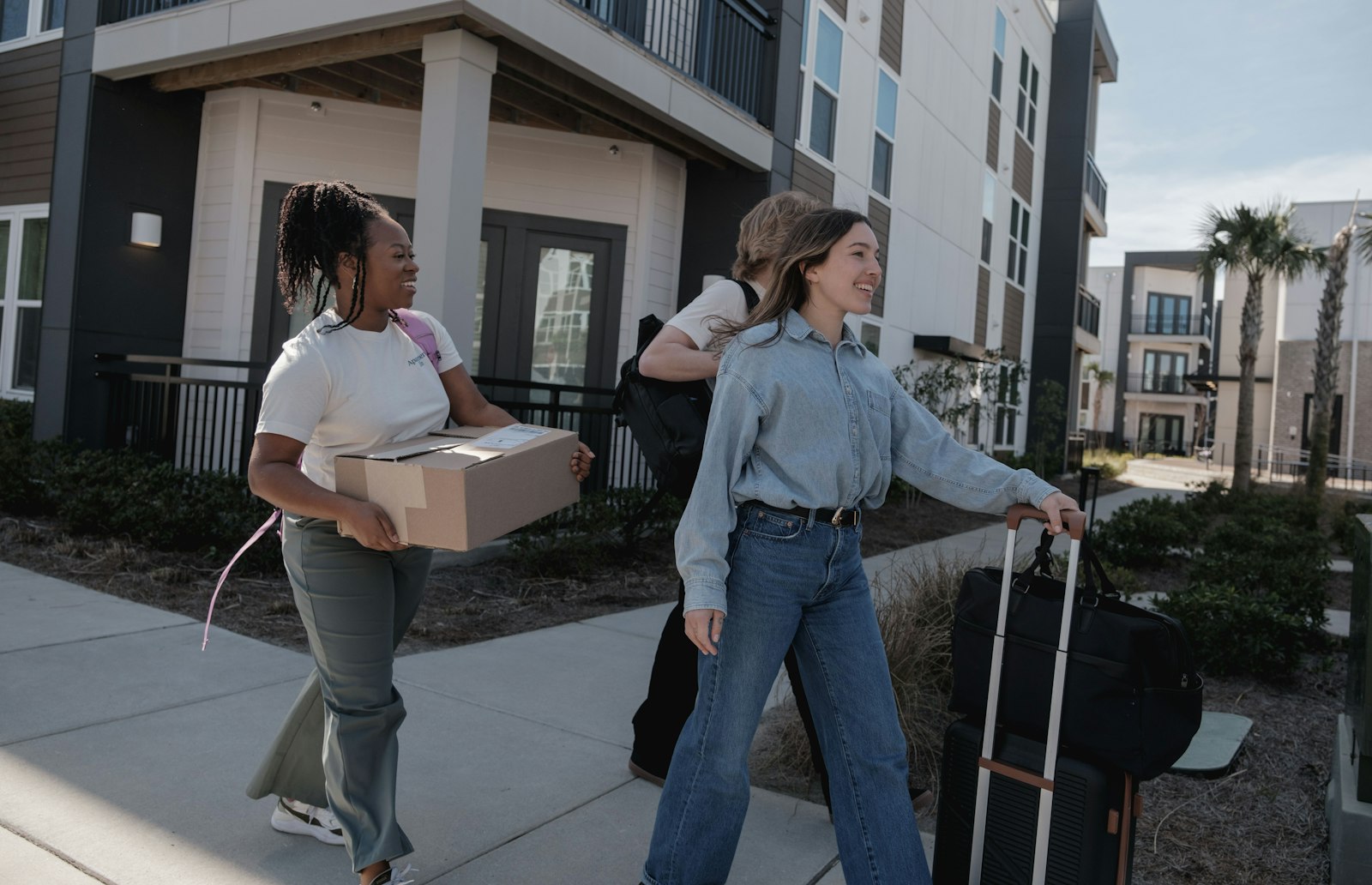 Students moving into their new home abroad with boxes and luggage