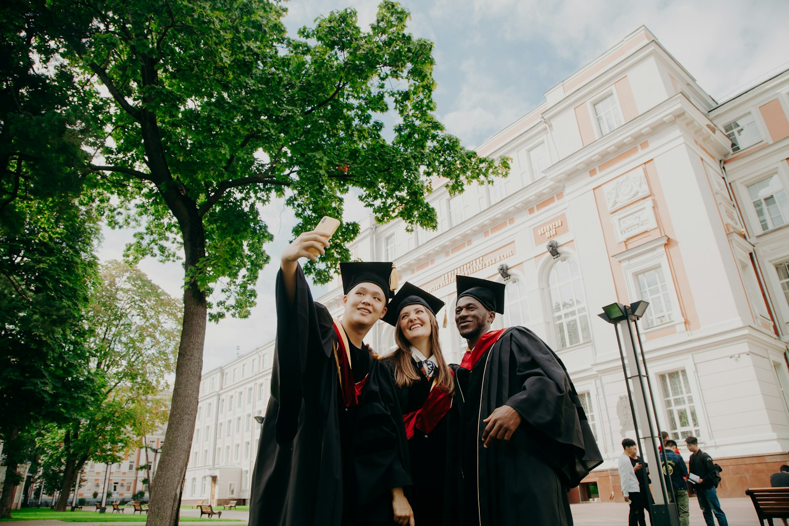 International students celebrating graduation in front of a university building